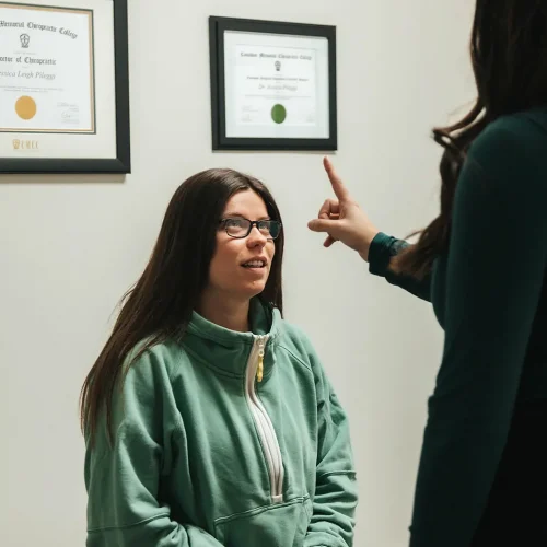 A woman is talking to a doctor in an office.